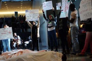 "John Jay College's Students for Justice in Palestine collaborating with John Jay College's African Student's Association and Debate Society stand up for justice together in solidarity from Ferguson to Palestine. The "bodies" represent those whose lives have been taken due to similar, unjust oppressive systems. Students holding posters showing solidarity from Ferguson to Palestine, occupation is a crime.", via CUNY John Jay FB Page, October 8 2014