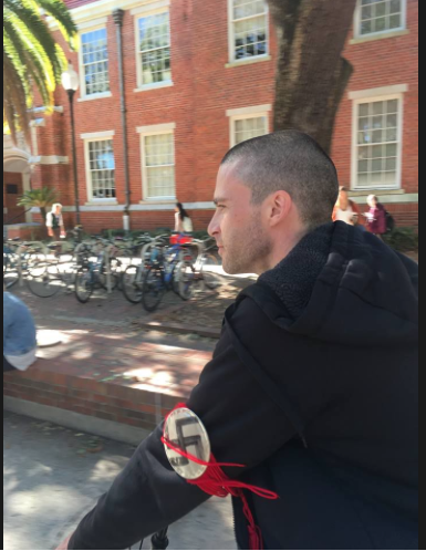 Source Credit: A man wearing a swastika armband rode his bicycle as the Jewish Student Union promotes Jewish Heritage Month (January 25, 2017)